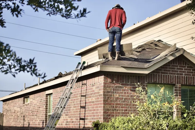 Professional roofer working on a residential roof in Brockway Corner